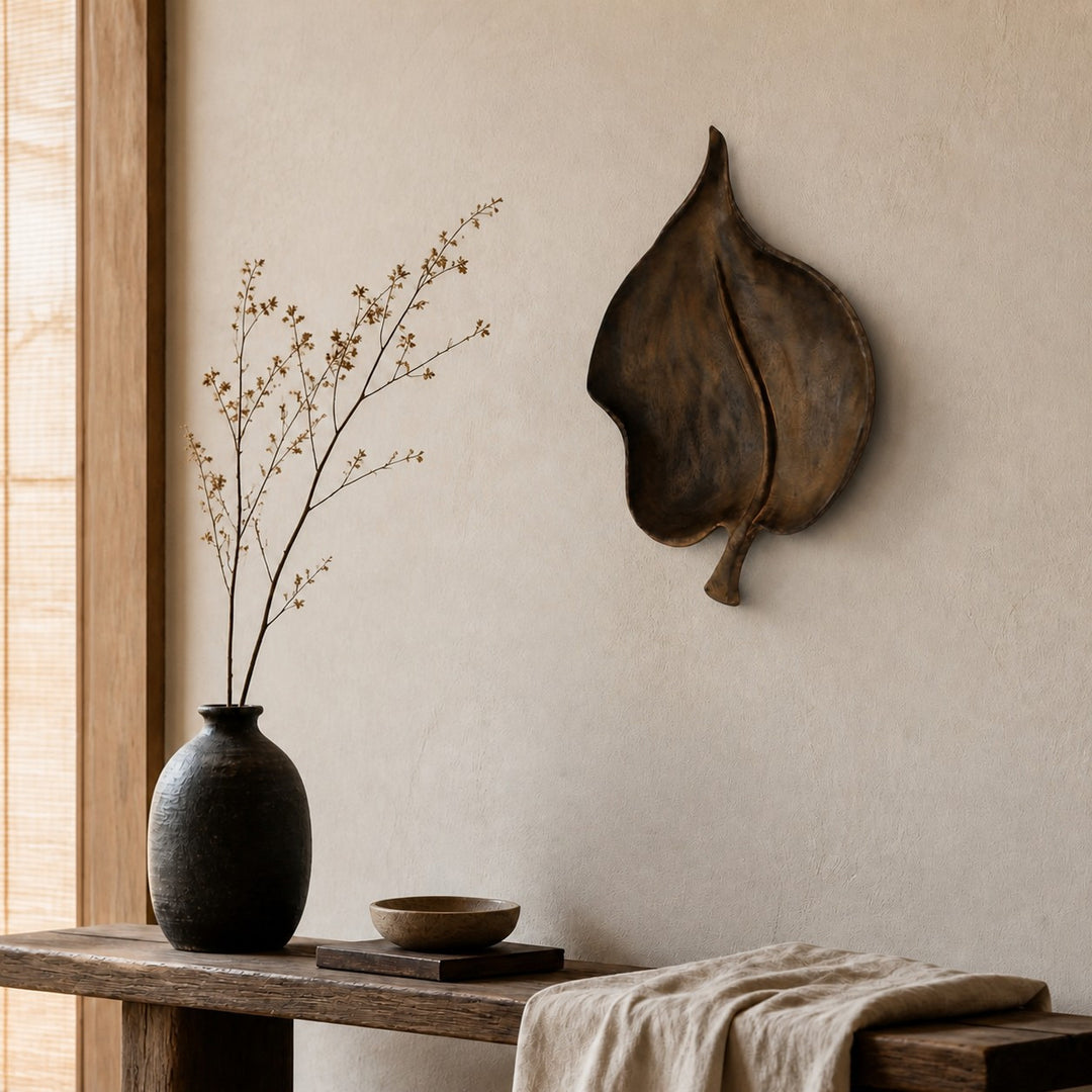 Small wooden leaf wall sculpture in a warm minimalist room