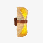 Bild in Gallery-Viewer laden, Beige natural loofah wall sconce with a brown leather band illuminated