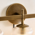 Bild in Gallery-Viewer laden, Close view of the tumbled-brass wall plate, bar joint and ribbed shade