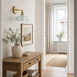 Bild in Gallery-Viewer laden, Blue milk glass brass wall sconce above an entry console