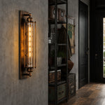Load image into Gallery viewer, Antique brass tube wall sconce in a loft hallway