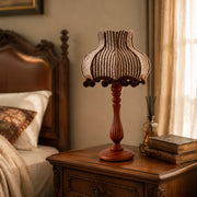 Vintage striped table lamp on a bedroom bedside table