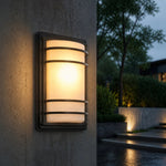 Cargar imagen en el visor de la Galería, Outdoor wall light glowing on a wet exterior wall
