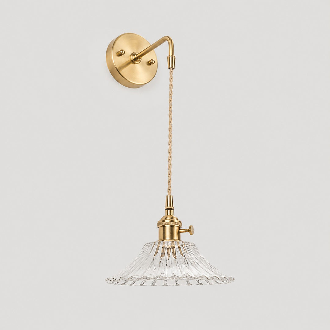 Clear shallow glass wall light with brass arm, W shade 6 cm high and 18 cm diameter