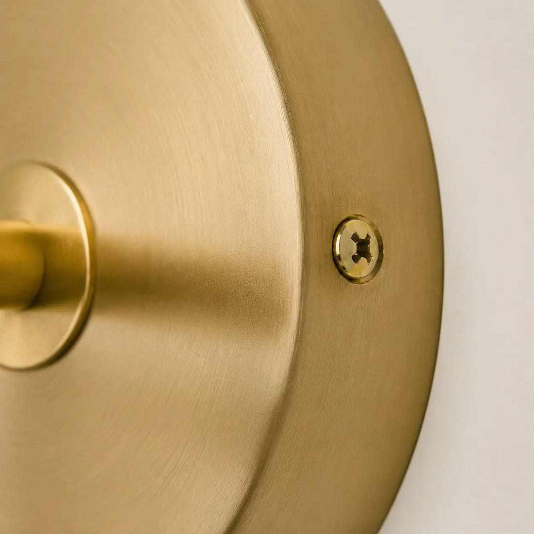 Close view of the brushed brass-tone round backplate