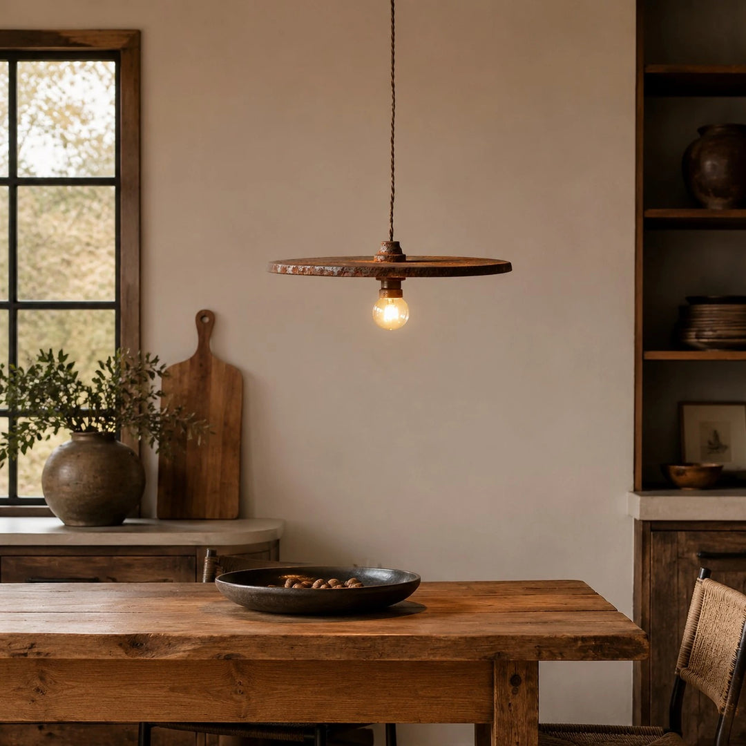 Rust brown pendant light above a dining table by a window