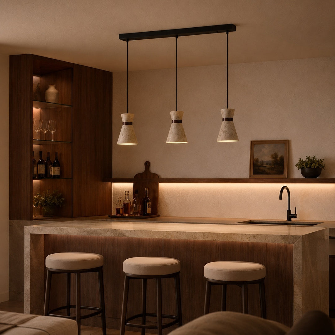 Three head travertine pendant light over a kitchen bar