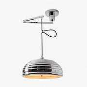 Adjustable chrome pendant light shown with a warm bulb installed