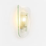 Bild in Gallery-Viewer laden, Clear glass wall sconce shown illuminated on a white background