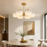 Load image into Gallery viewer, 6-light gold chandelier above a modern dining table