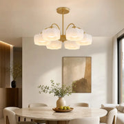 6-light gold chandelier above a modern dining table