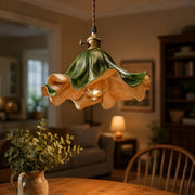 Dark green leather pendant light above a dining table