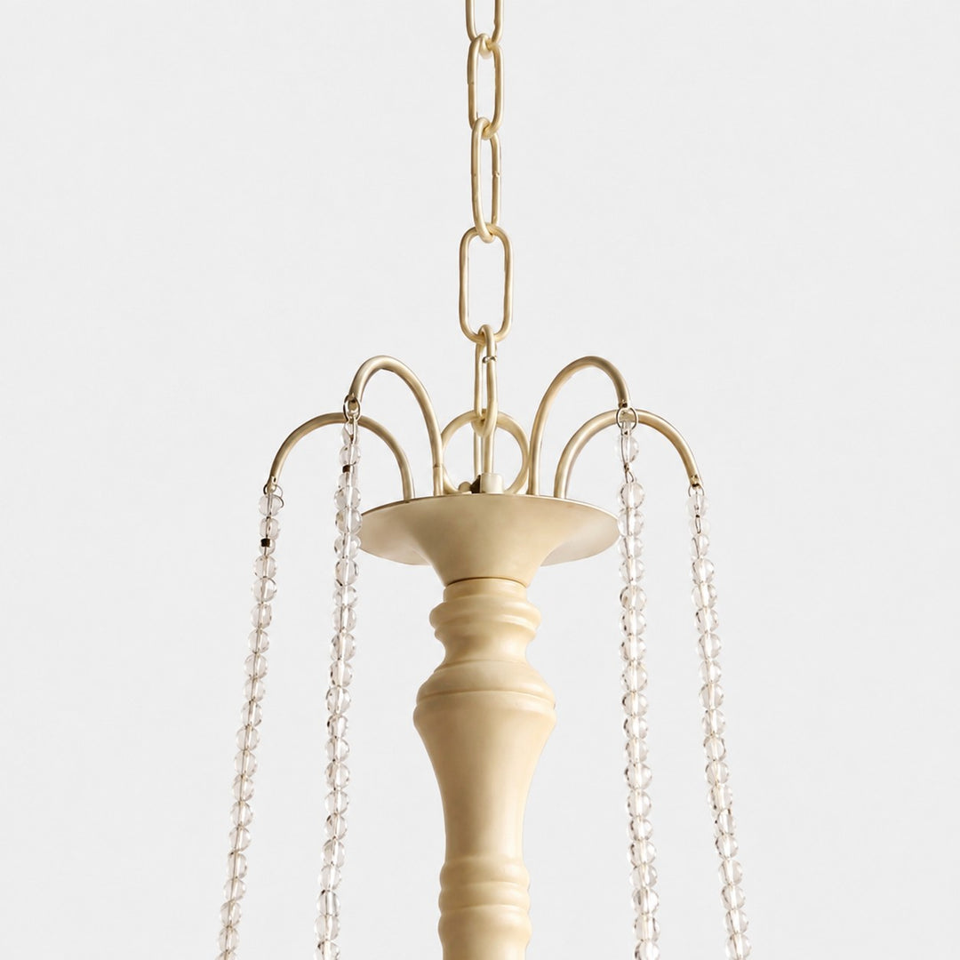 Close-up of gold-tone hanging chain and crystal bead suspension details