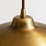 Load image into Gallery viewer, Close view of the antique brass surface and cord connection