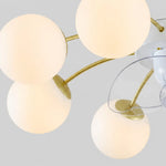 Bild in Gallery-Viewer laden, Close-up of white glass globes and gold-toned arms