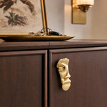 Load image into Gallery viewer, Abstract brass face cabinet knob on dark wood cabinetry