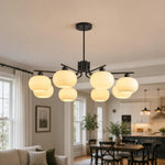 Bild in Gallery-Viewer laden, Black milk glass chandelier in a contemporary living space