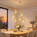 Charger l'image dans la visionneuse de galerie, White six-light glass pendant over a dining table at sunset
