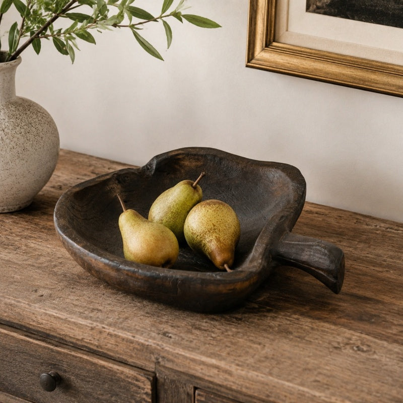 Apple-shaped wooden serving board styled with fruit