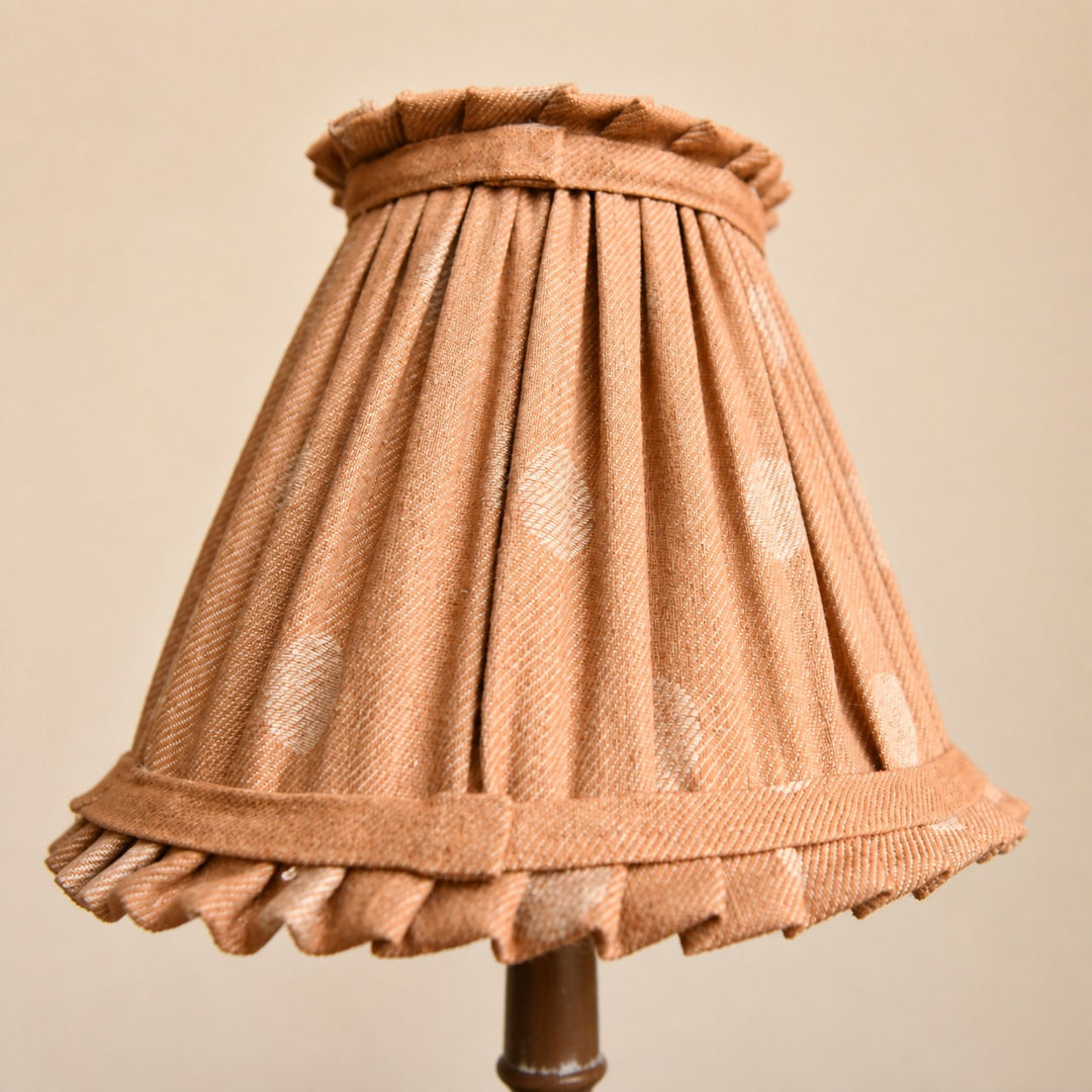 Pleated cloth lampshade close detail on French country table lamp
