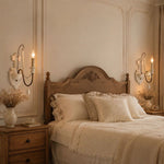 Load image into Gallery viewer, One-light wall sconce installed beside a bedroom headboard