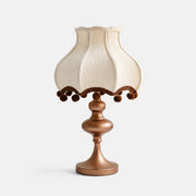 Cream fabric pom-pom table lamp with brown trim