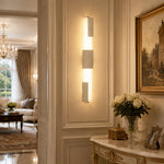 Charger l'image dans la visionneuse de galerie, Yellow travertine acrylic wall lamps installed as a vertical pair on paneled wall