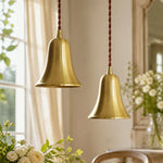 Load image into Gallery viewer, Pair of natural brass bell pendant lights in an elegant interior