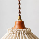 Charger l'image dans la visionneuse de galerie, Close-up of twisted brown cord, brass fitting and warm wood socket cover