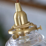 Cargar imagen en el visor de la Galería, Brass glass pendant light installed over a kitchen counter