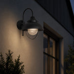 Bild in Gallery-Viewer laden, Black seeded-glass wall lamp creating a warm evening accent
