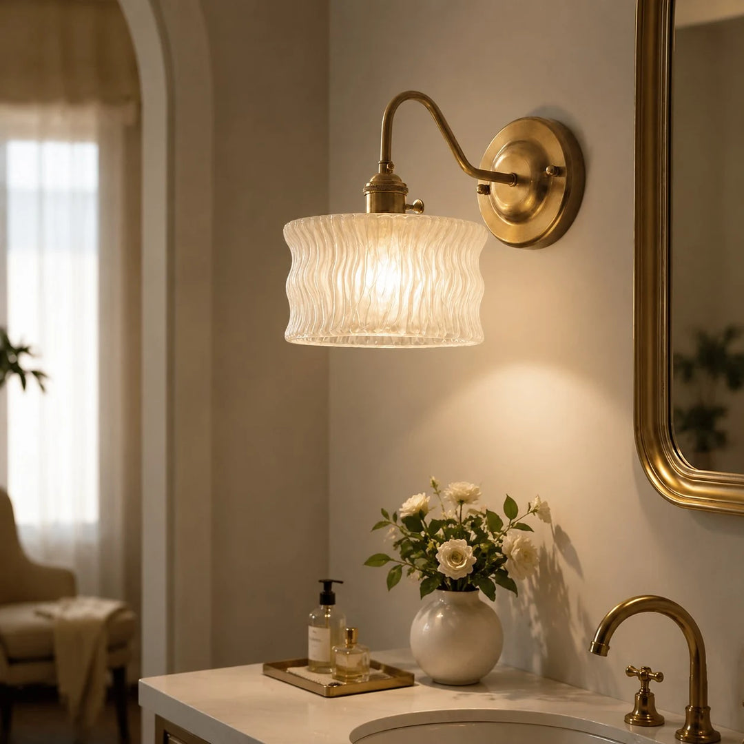 Frosted ripple glass wall sconce above a vanity counter