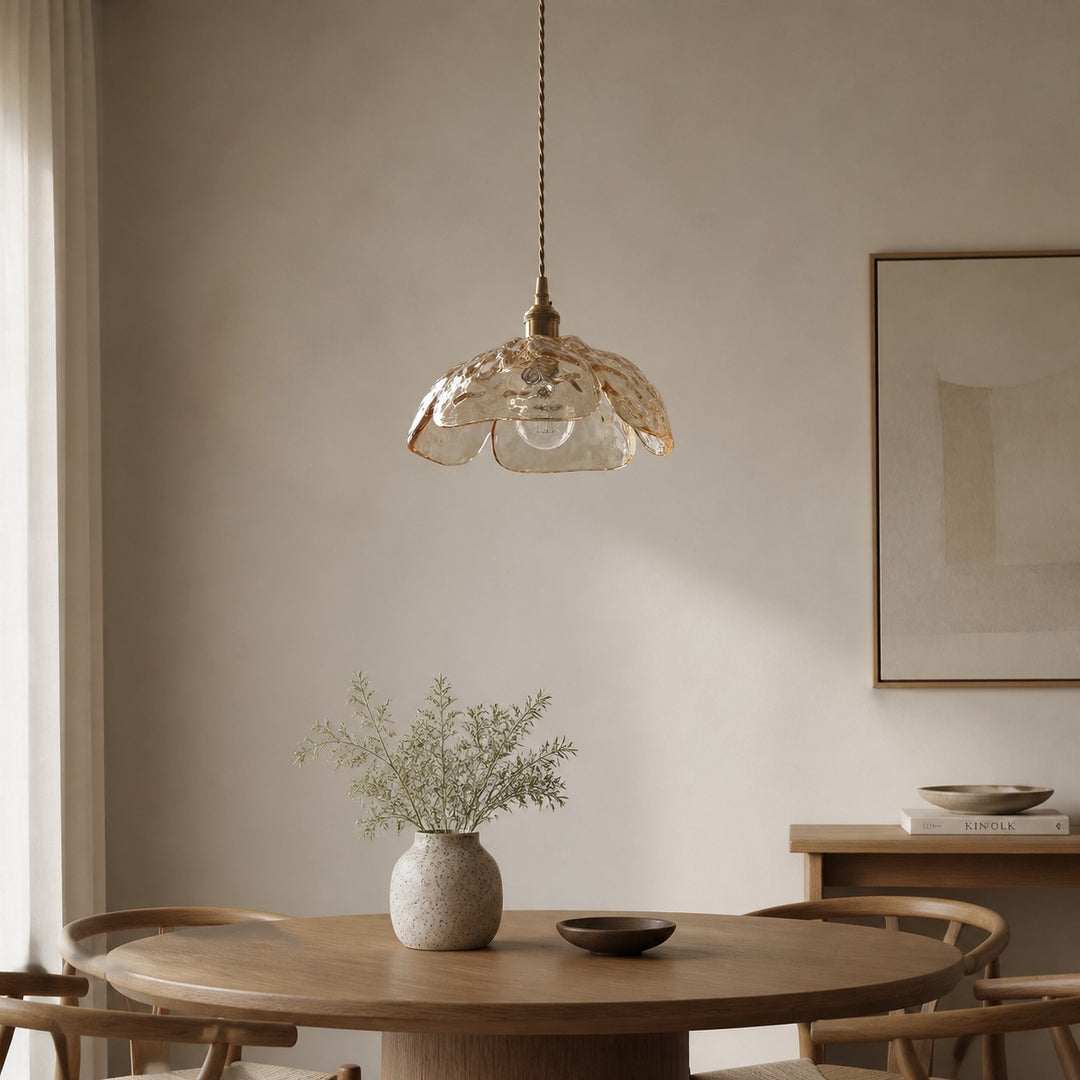 Clear walnut-accent pendant in a calm dining space