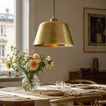Load image into Gallery viewer, Bright brass pendant lamp above a dining table