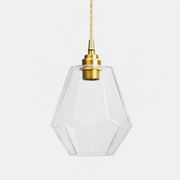 Clear faceted glass pendant light with antique brass holder on white background