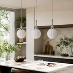 Bild in Gallery-Viewer laden, Three ribbed glass pendants above a kitchen island