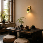 Cargar imagen en el visor de la Galería, Green jade wall sconce illuminating a warm dining space
