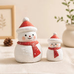 Cargar imagen en el visor de la Galería, Two wooden snowman ornaments styled with holiday decor