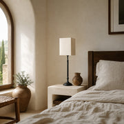Square fabric shade table lamp in a bedroom
