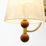 Bild in Gallery-Viewer laden, Close-up of warm wood sphere accents below the shell shade