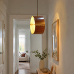 Bild in Gallery-Viewer laden, Hand-laced leather cylinder pendant light in an interior setting