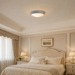 Cargar imagen en el visor de la Galería, Gray flush mount ceiling light in a soft bedroom setting