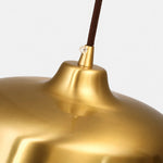 Load image into Gallery viewer, Close view of the bright brass surface and cord connection