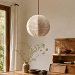 Charger l'image dans la visionneuse de galerie, Ivory woven globe pendant suspended above a warm wooden dining table