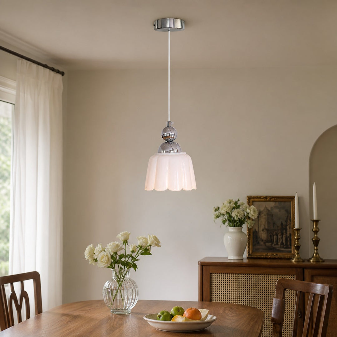 White ceramic pendant lamp above a dining table