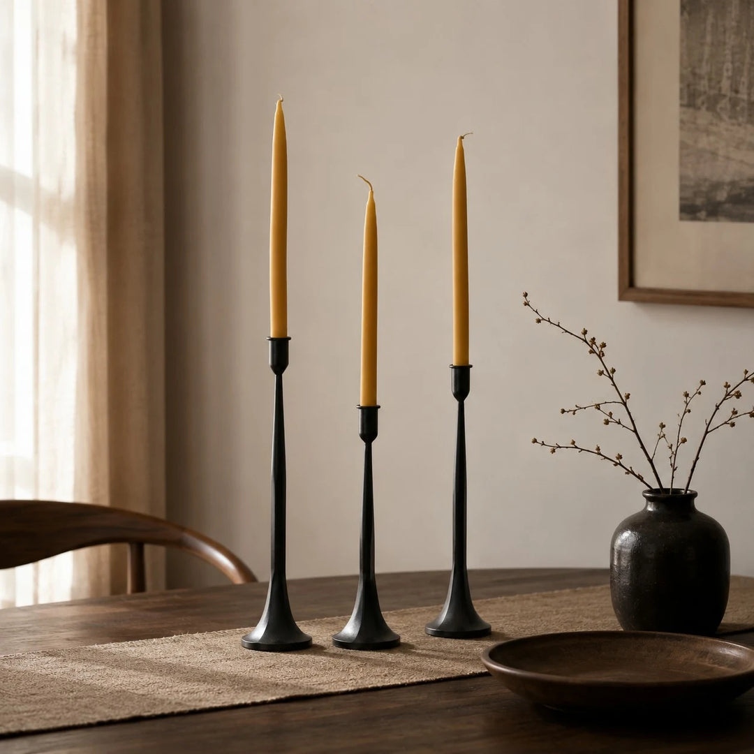 Three taper candle holders styled in a calm dining room setting