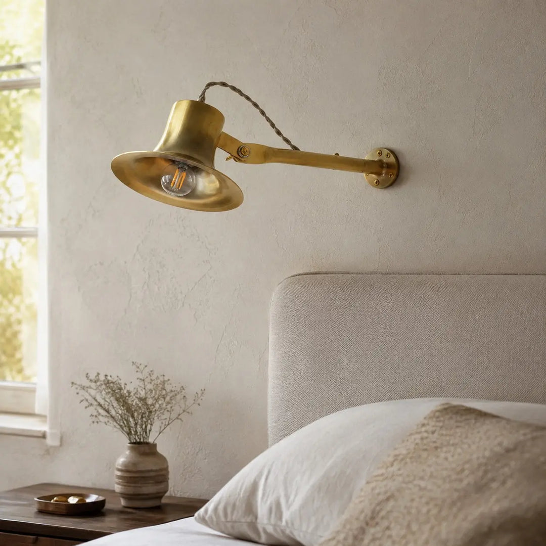 Matte brass wall light in a bedroom