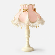 Blush pink satin lace table lamp on a light background