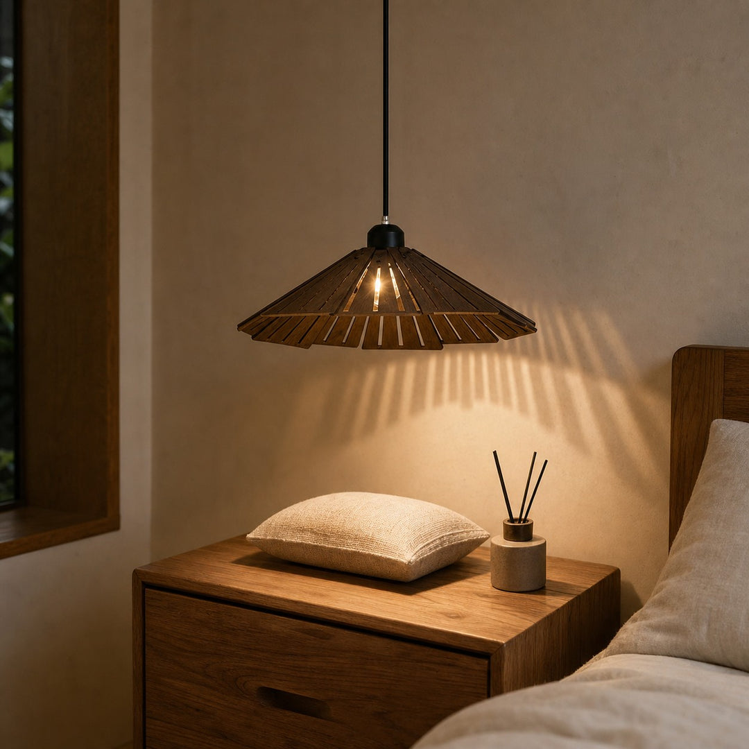 Wooden pendant light above a bedside table