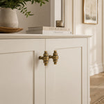 Load image into Gallery viewer, Paired antique brass handles on cabinet doors